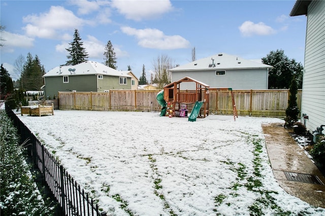 snowy yard with a playground