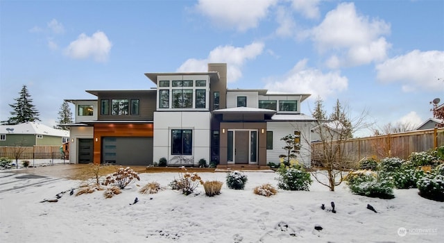 snow covered house with a garage