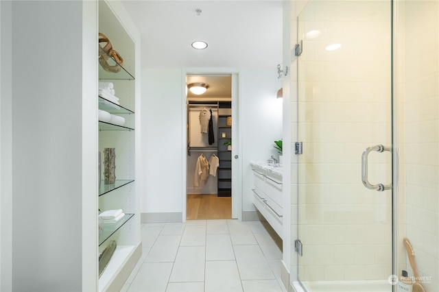 bathroom featuring tile patterned flooring, vanity, and walk in shower