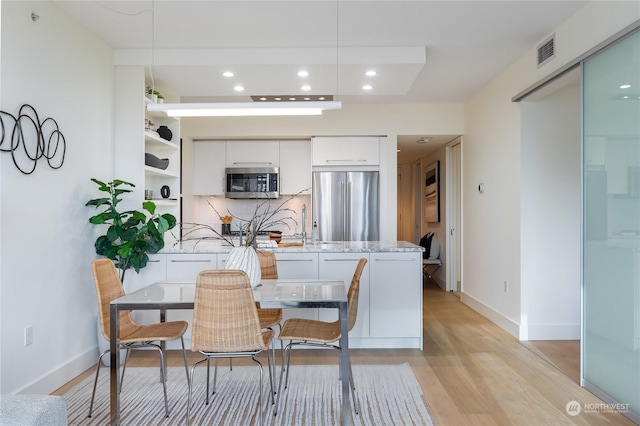 dining space featuring light hardwood / wood-style floors