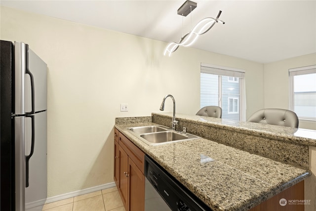 kitchen featuring sink, appliances with stainless steel finishes, kitchen peninsula, and a healthy amount of sunlight