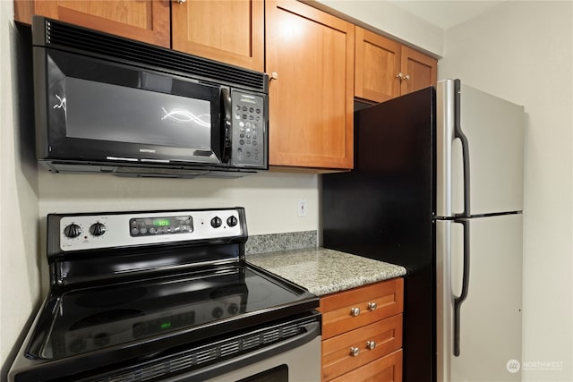 kitchen featuring light stone countertops and appliances with stainless steel finishes