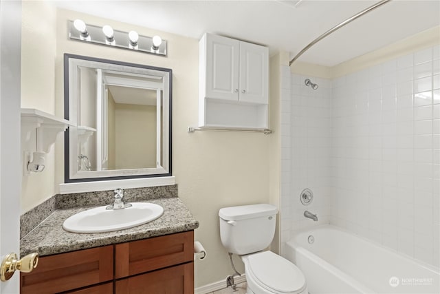 full bathroom with toilet, vanity, and tiled shower / bath combo