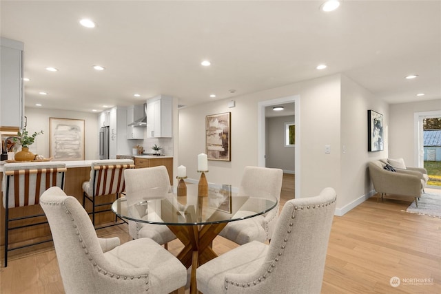 dining area featuring sink and light wood-type flooring