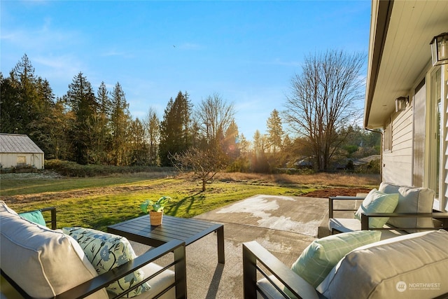 view of patio / terrace with an outdoor hangout area and a storage shed