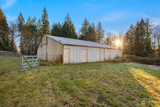 outdoor structure at dusk featuring a lawn