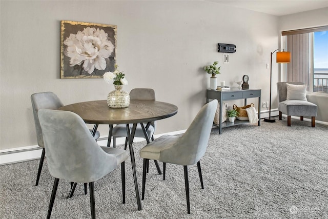 dining room featuring baseboard heating and carpet