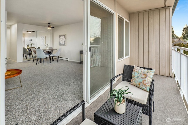 balcony with ceiling fan and a baseboard heating unit