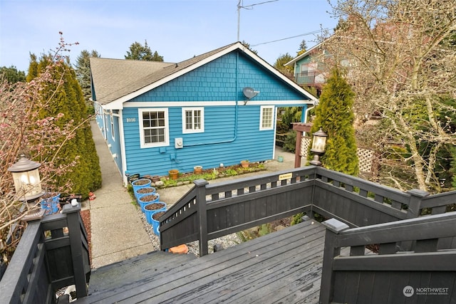 rear view of property featuring a deck