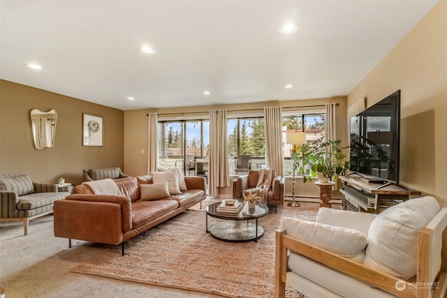 living room with carpet flooring and a baseboard heating unit