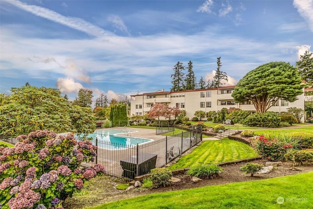 view of swimming pool with a lawn