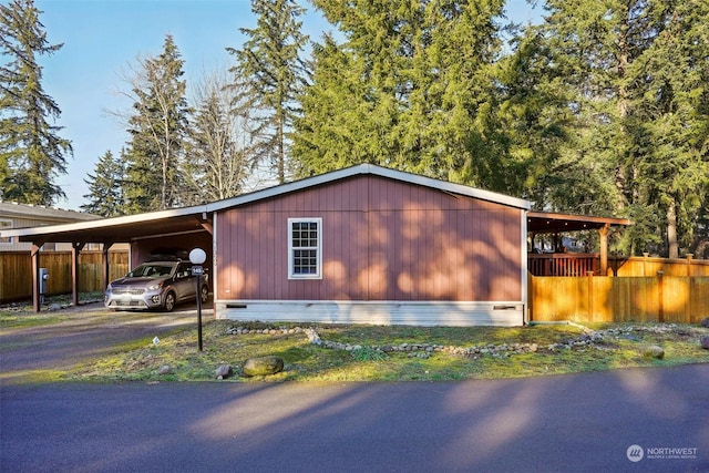 view of side of home with a carport