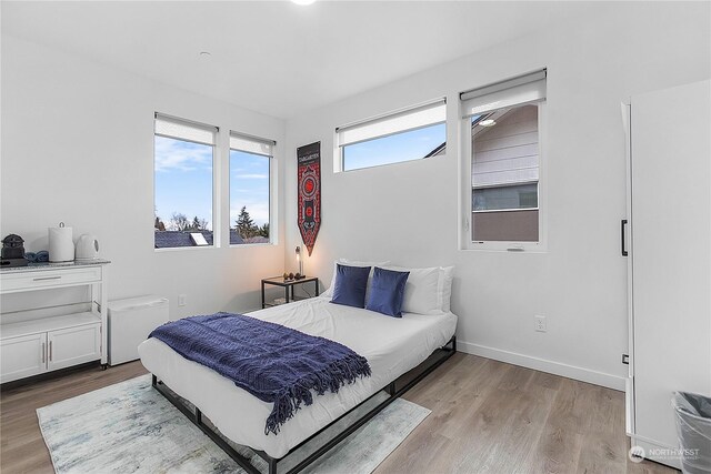 bedroom with light hardwood / wood-style flooring