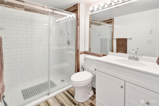 bathroom with a shower with shower door, hardwood / wood-style flooring, and toilet