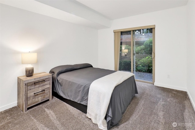 bedroom featuring access to exterior and dark carpet