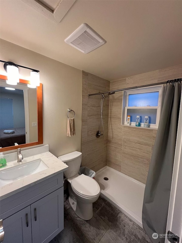 bathroom featuring vanity, toilet, and a shower with curtain