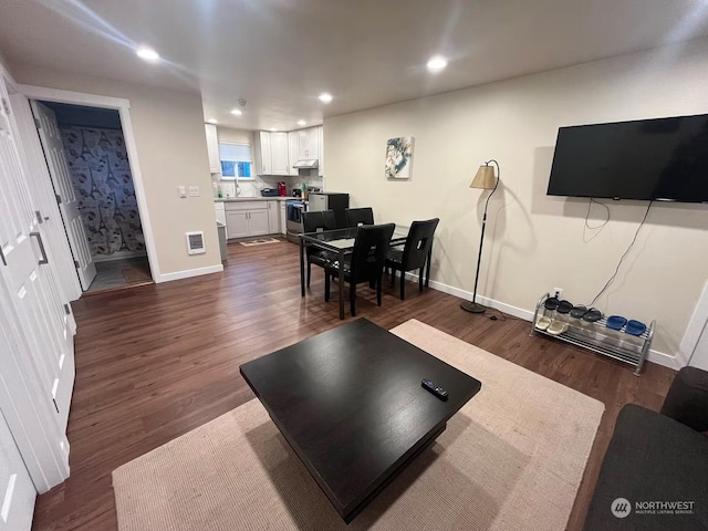 living room with sink and dark hardwood / wood-style flooring