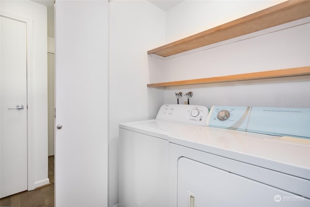 laundry area with dark hardwood / wood-style flooring and independent washer and dryer