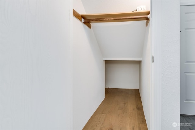 interior space with vaulted ceiling and hardwood / wood-style floors