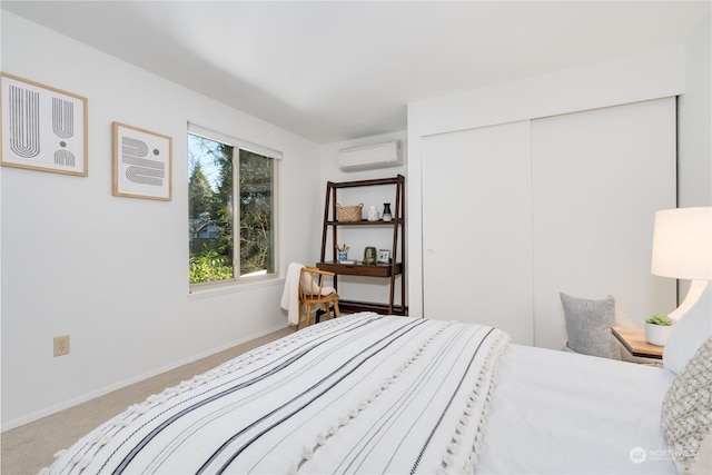 carpeted bedroom with a closet and a wall unit AC