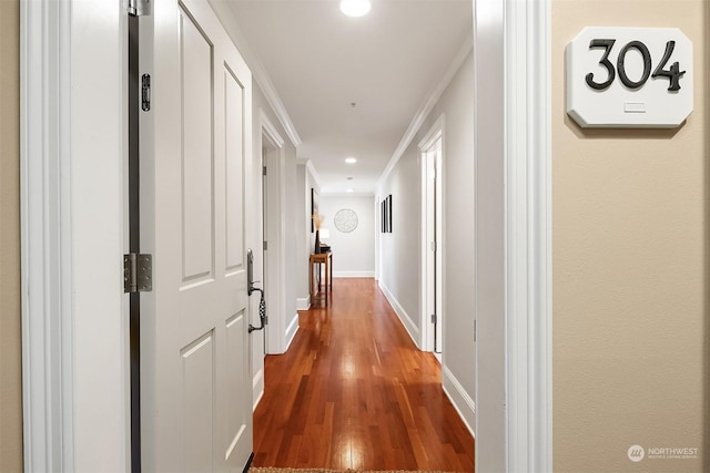 hall featuring ornamental molding and wood-type flooring