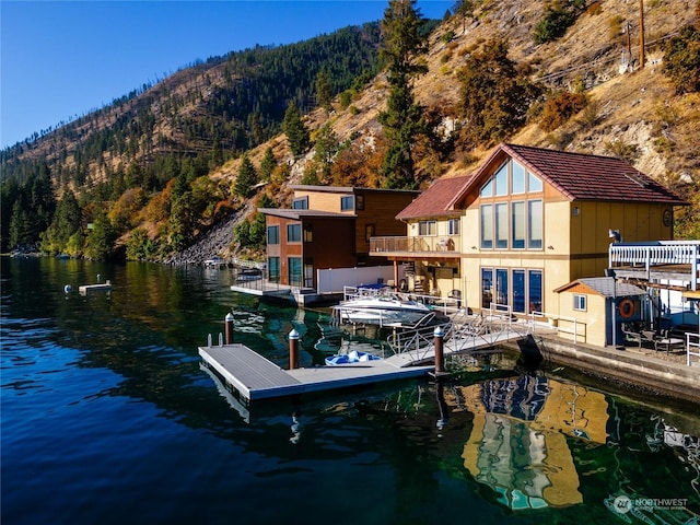 view of dock with a water and mountain view