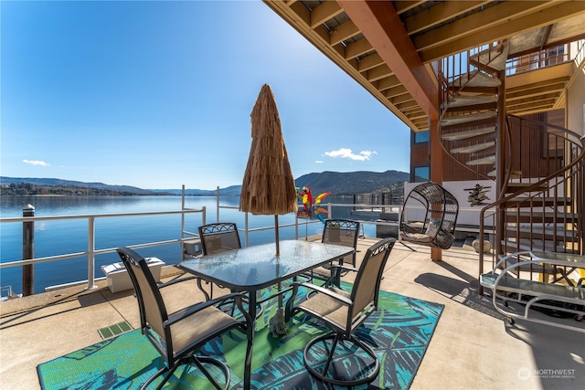 view of patio with a water and mountain view