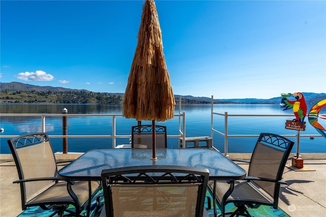 view of patio featuring a water and mountain view