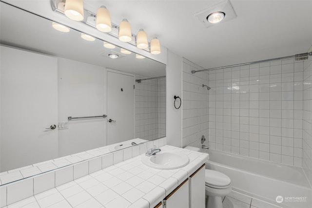 full bathroom featuring toilet, tiled shower / bath, tile patterned floors, and vanity