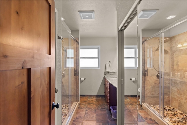 bathroom featuring walk in shower and vanity