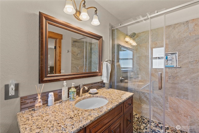 bathroom with walk in shower and vanity