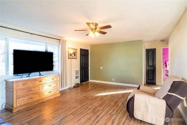 living room featuring ceiling fan and hardwood / wood-style floors