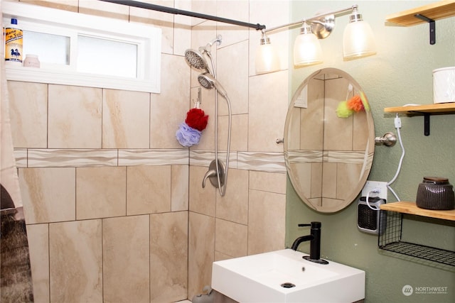 bathroom featuring sink and tiled shower