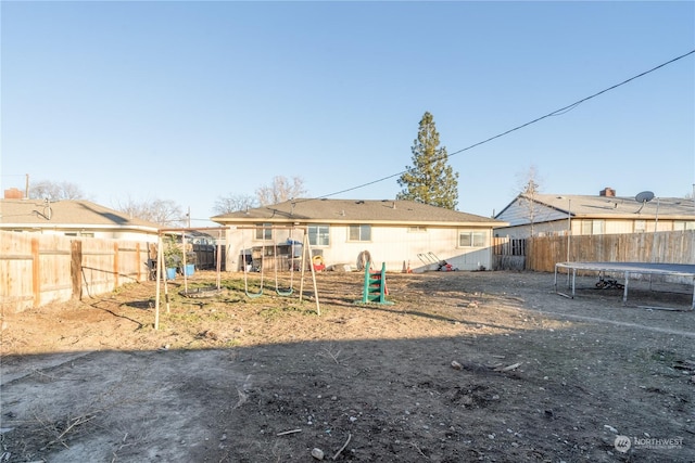 rear view of house with a trampoline