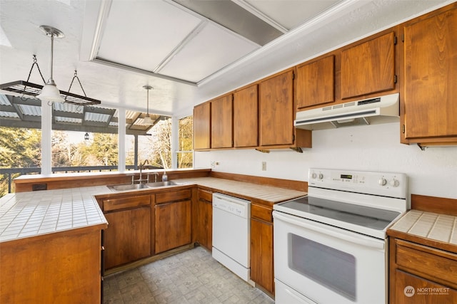 kitchen featuring pendant lighting, sink, white appliances, and tile countertops