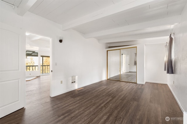 unfurnished room with beamed ceiling and dark hardwood / wood-style flooring