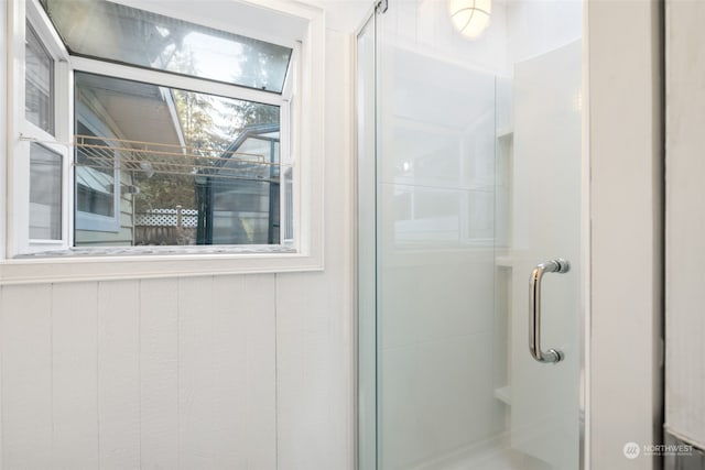 bathroom with a shower with shower door