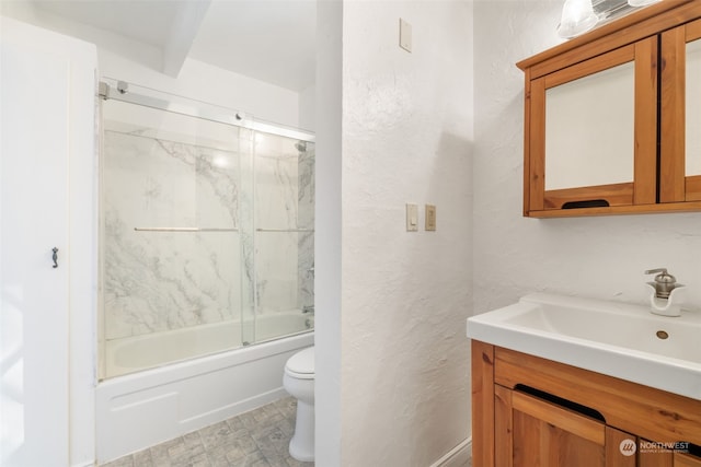 full bathroom with enclosed tub / shower combo, vanity, and toilet