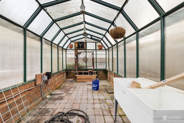 sunroom featuring vaulted ceiling