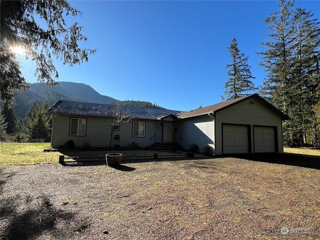 ranch-style home featuring a mountain view and a garage