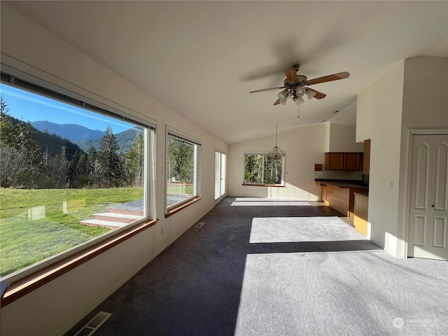 sunroom featuring ceiling fan and vaulted ceiling