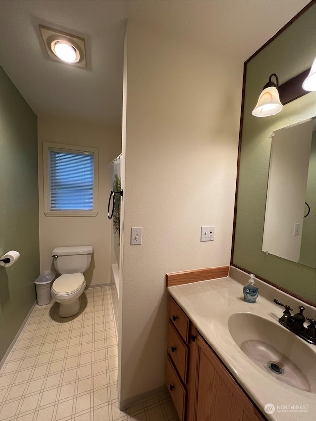 bathroom featuring vanity, a shower with shower curtain, and toilet