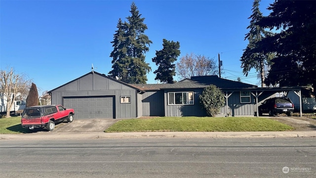 ranch-style house featuring a garage, a front lawn, and a carport