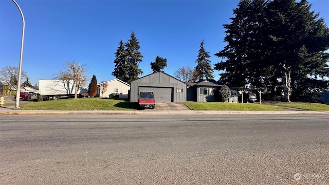 ranch-style house with a garage and a front yard