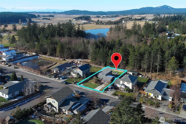 bird's eye view with a water and mountain view