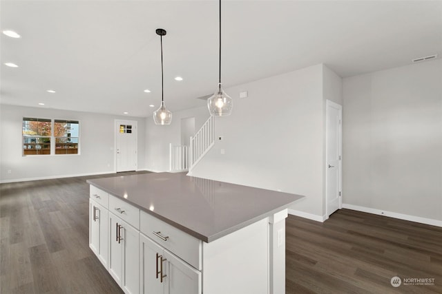 kitchen with a kitchen island, pendant lighting, dark hardwood / wood-style flooring, and white cabinets