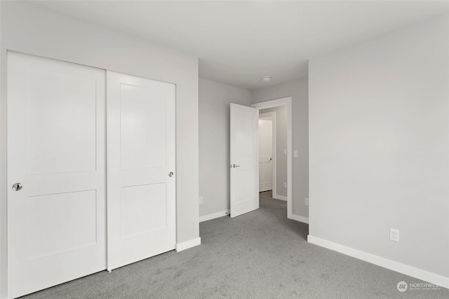 unfurnished bedroom with a closet and carpet floors