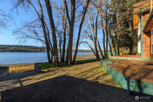 view of yard with a deck with water view