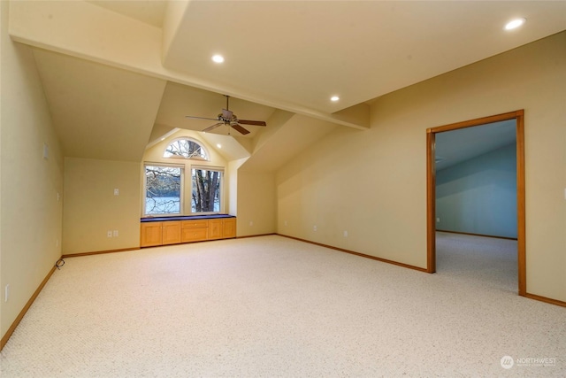 additional living space featuring vaulted ceiling, carpet, and ceiling fan