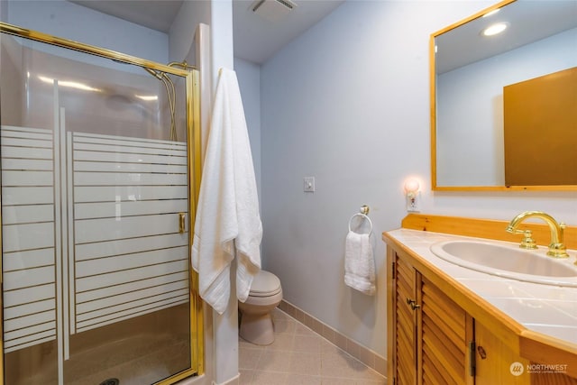 bathroom featuring vanity, toilet, a shower with door, and tile patterned flooring